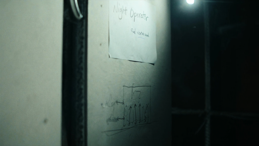 Handwritten note left on drywall for the next shift with a rough diagram sketched beside it