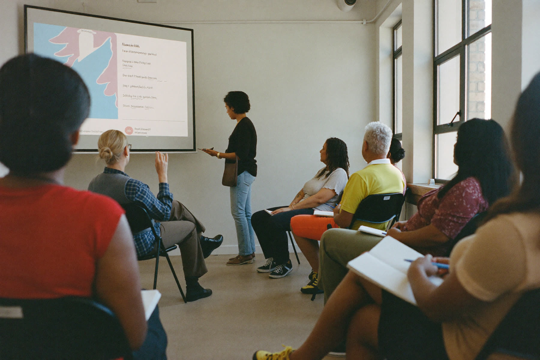 A speaker presenting to a group at a community workshop