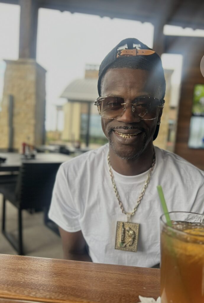 David Hawkins wearing the gold Chicago Minded pendant