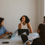 A small diverse team in conversation around a table