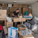 A small business owner packing orders in a warehouse