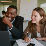 Two colleagues reviewing performance reports together