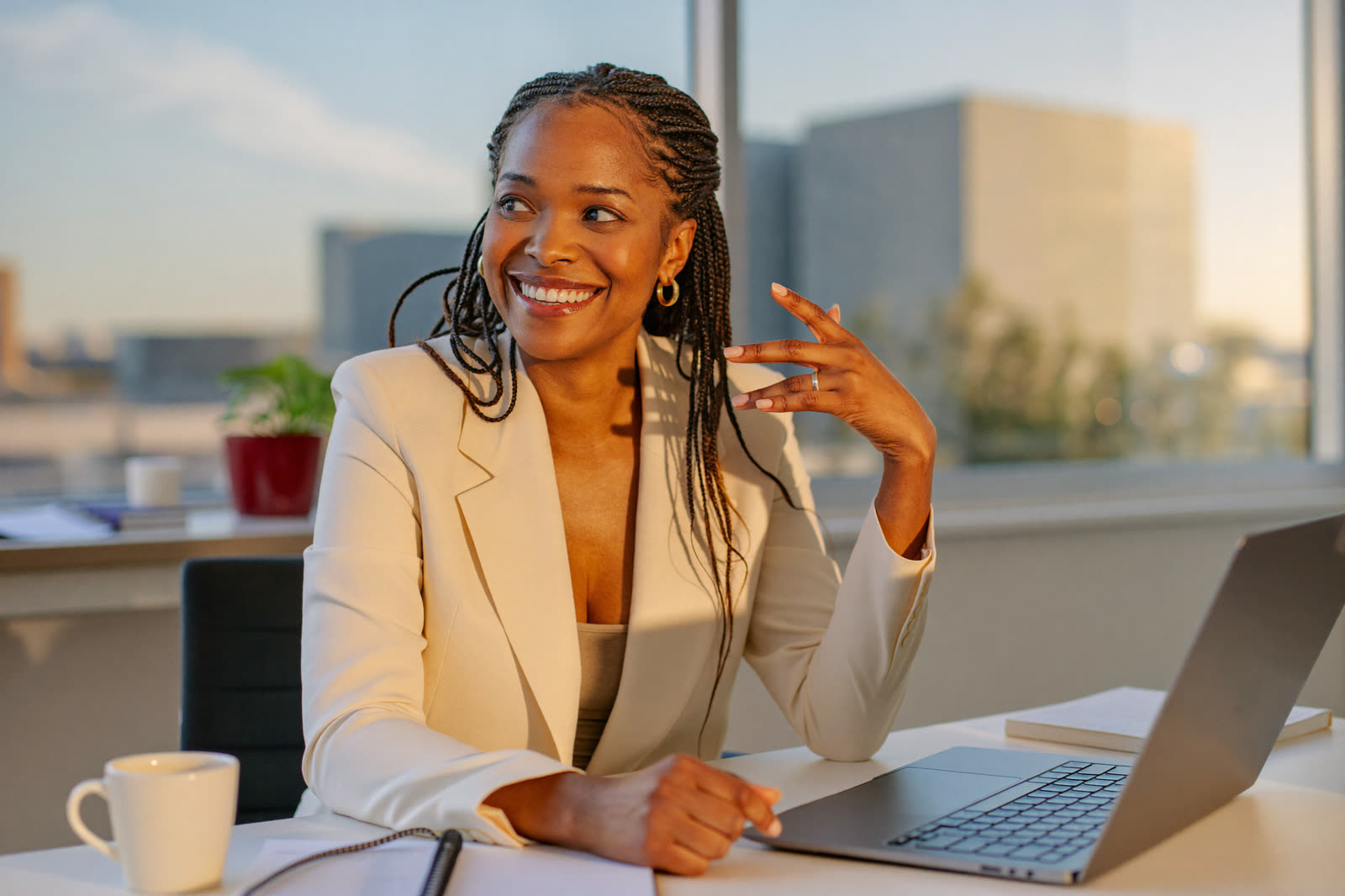 A woman entrepreneur smiling at her desk, ready to connect