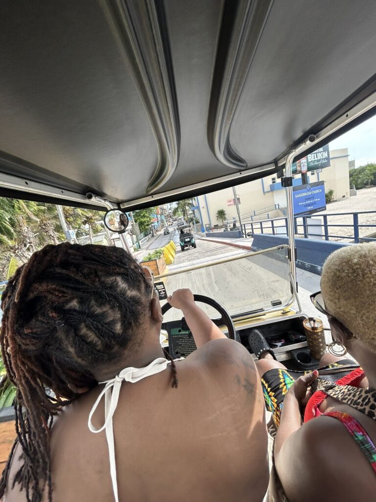 Riding through San Pedro, Belize in a golf cart, view from the back seat